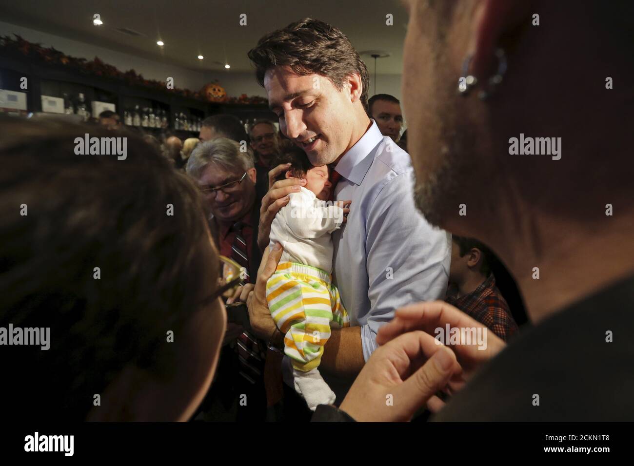 Liberal leader Justin Trudeau holds five-week old Hannah Levesque during a campaign stop in Stratford, Ontario October 13, 2015. Canadians will go to the polls in a federal election on October 19. REUTERS/Chris Wattie Stock Photo