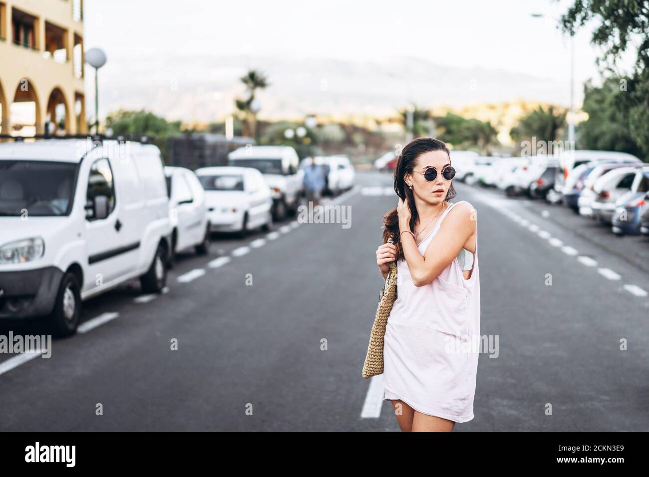 Pretty long hair brunette girl walking on the street Stock Photo - Alamy