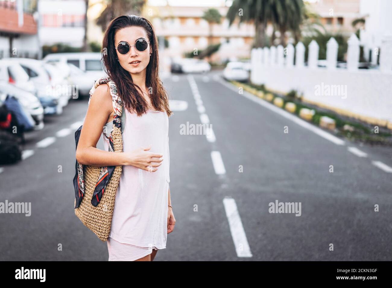 Pretty long hair brunette girl walking on the street Stock Photo - Alamy