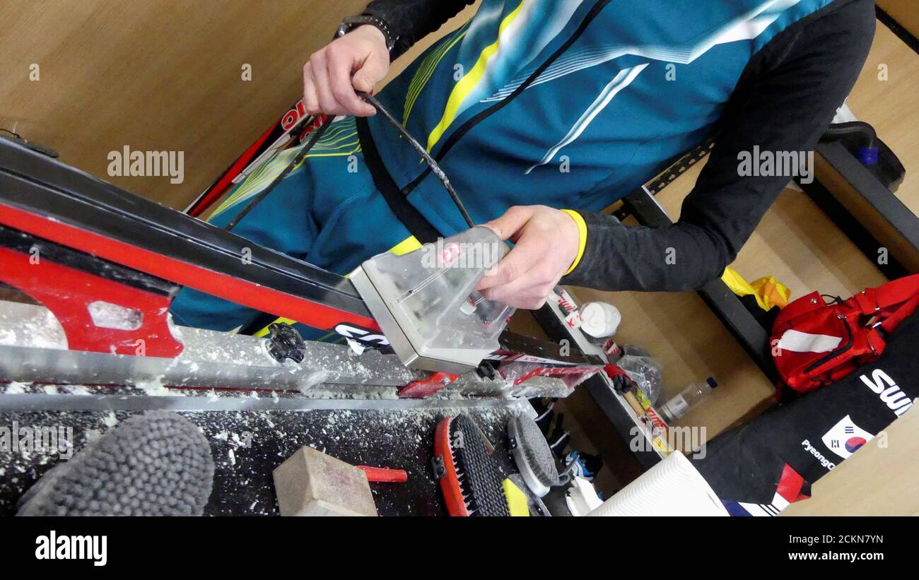Wax technician Paul Moore of the Australian cross-country ski team works on a set of skis during the Pyeongchang 2018 Winter Olympics, in Pyeongchang, South Korea, February 20, 2018. Picture taken February 20, 2018. REUTERS/Philip O'Connor Stock Photo
