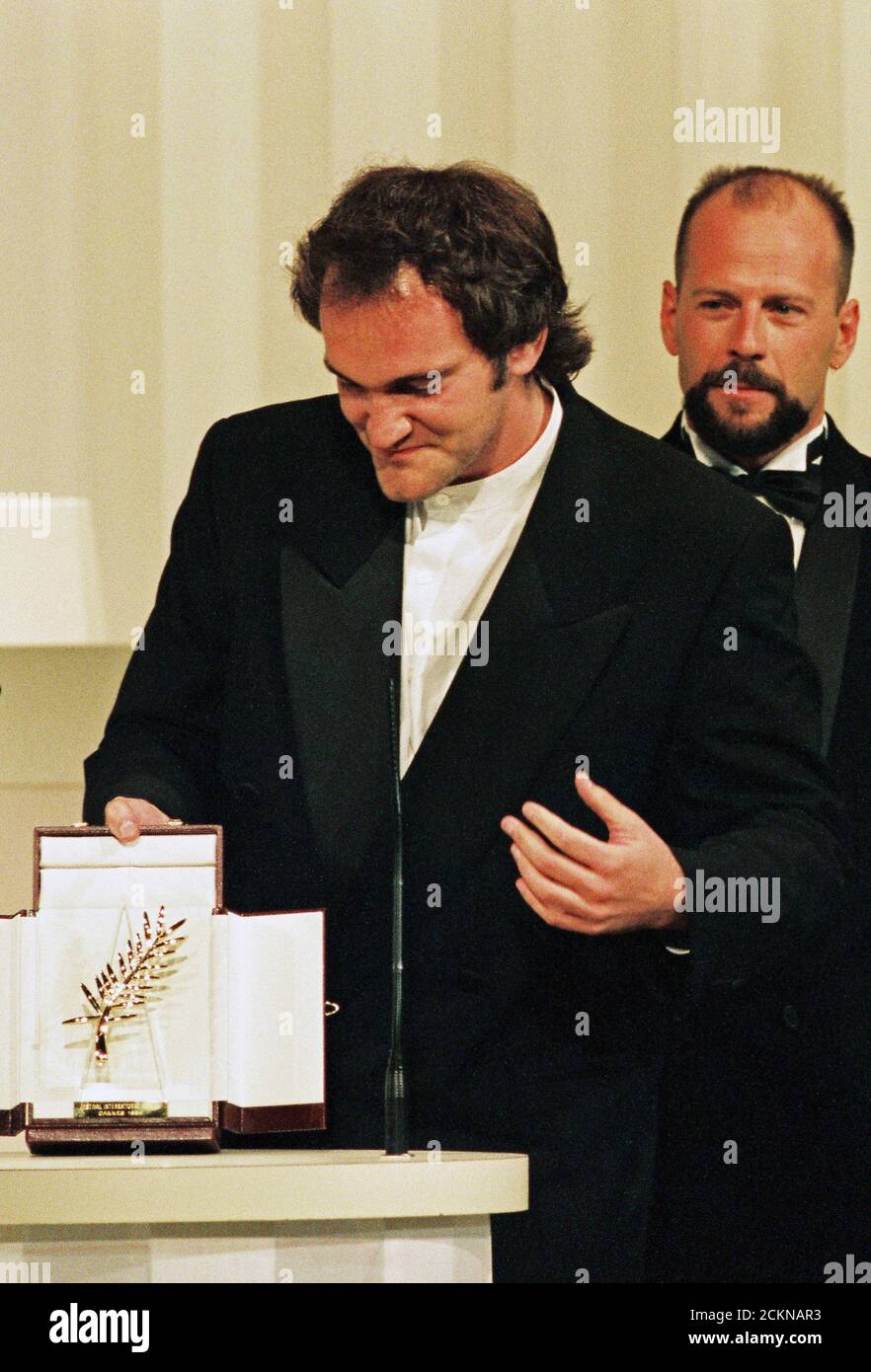 Director Quentin Tarantino reacts after winning the Palme d'Or award for  his film "Pulp Fiction" as actor Bruce Willis looks on during the closing  ceremony at the 47th Cannes Film Festival, in