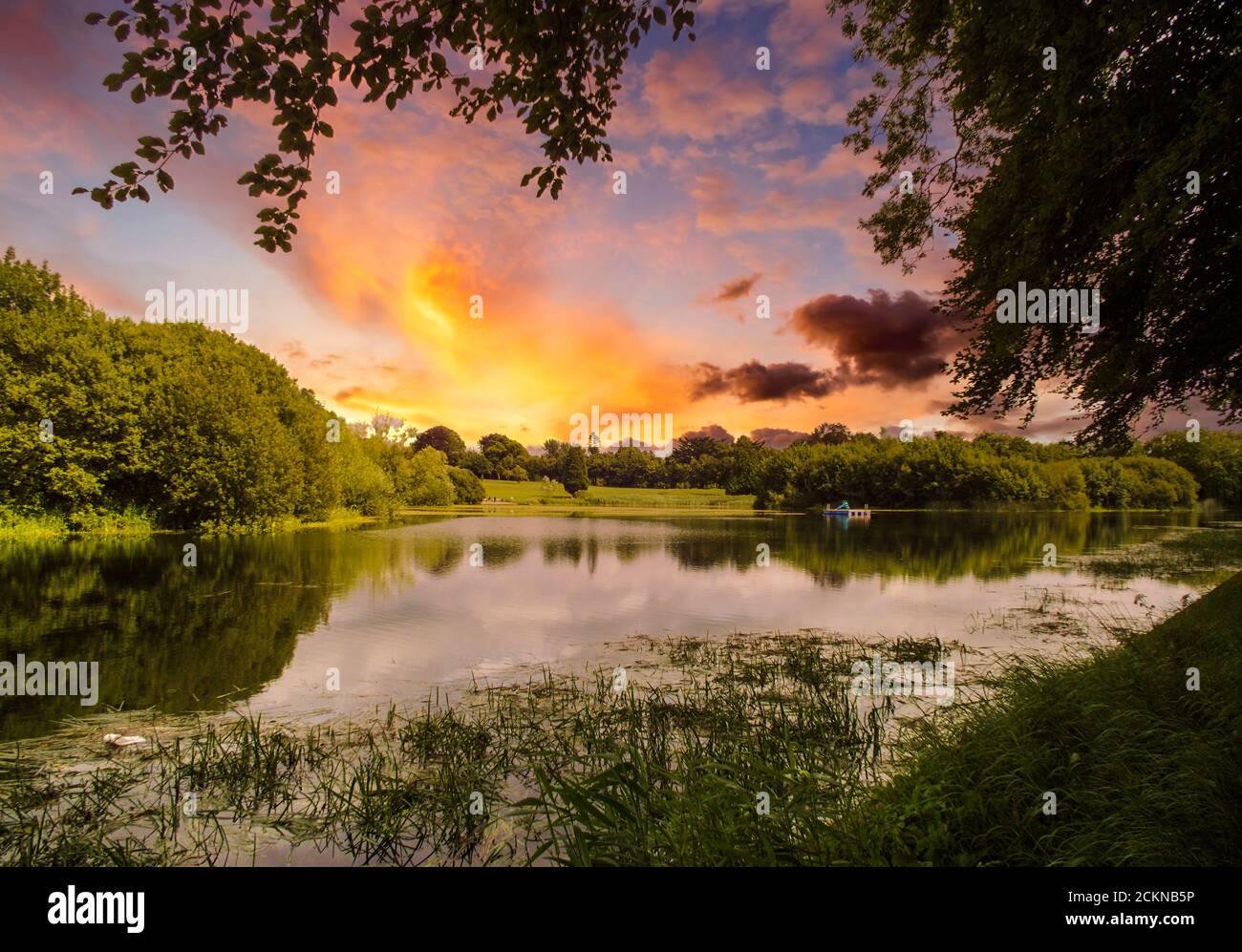 Image of a lake and colourful clouds during sunset. Stock Photo