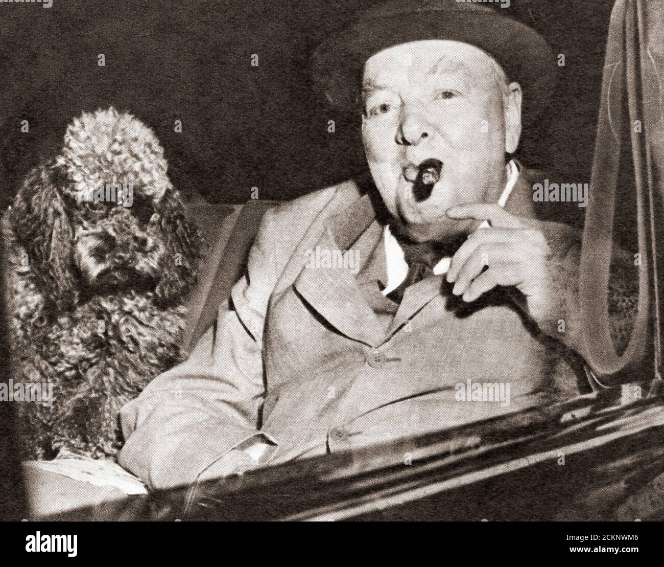 Winston Churchill, seen here with his pet poodle Rufus II.  Sir Winston Leonard Spencer-Churchill, 1874 – 1965. British politician, army officer, writer and twice Prime Minister of the United Kingdom. Stock Photo