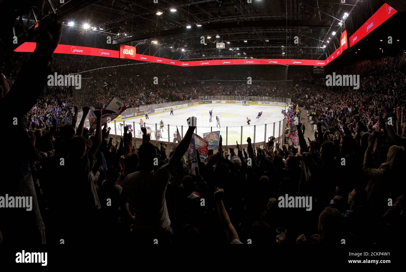 Fans of ZSC Lion celebrate after their team scored during a Swiss ice hockey play-off game against SC Bern (SCB) at the Hallenstadion arena in Zurich April 14, 2012. REUTERS/Arnd Wiegmann (SWITZERLAND - Tags: SPORT ICE HOCKEY) Stock Photo