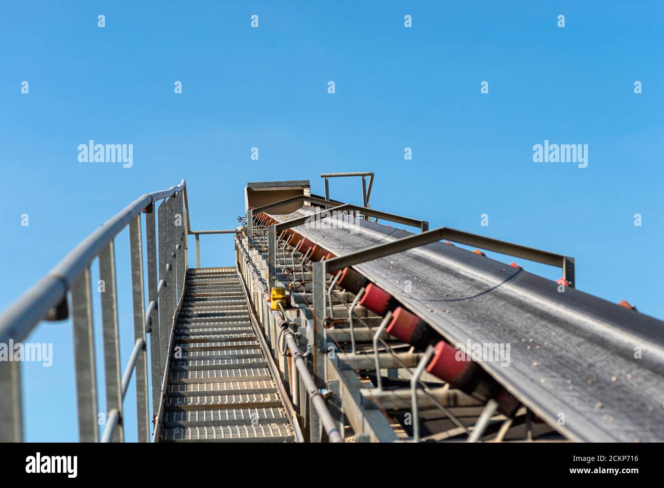 Closeup shot of the conveyor belt in the concrete plant with transport rollers, visible metal