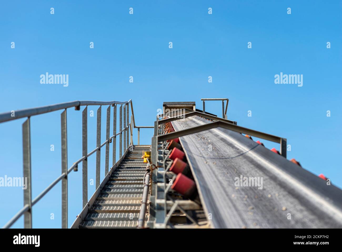 Closeup shot of the conveyor belt in the concrete plant with transport rollers, visible metal