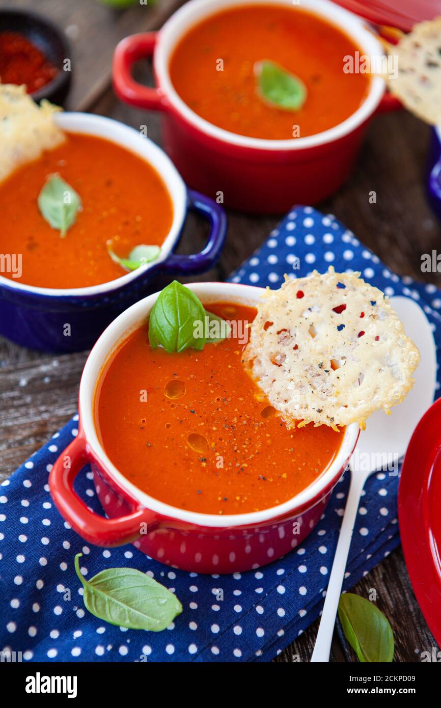 Homemade tomato soup in little pots with parmesan crackers Stock Photo
