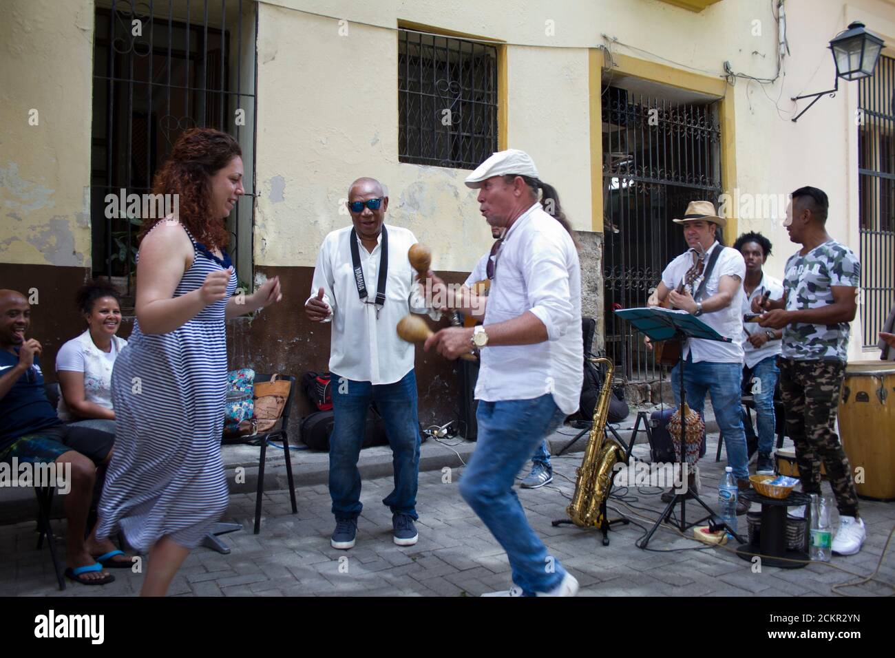Havana band playing salsa at a lunchtime restaurant, and getting tourists involved Stock Photo