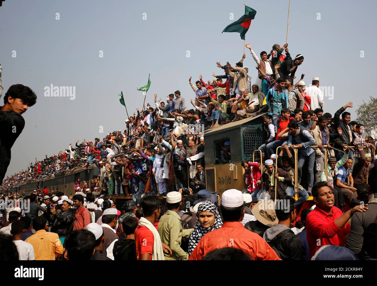 An overcrowded train leaves Tongi rail station after the final prayer of 'Bishwa Ijtema', the world congregation of Muslims, on the banks of the Turag river in Tongi near Dhaka January 15, 2017. REUTERS/Mohammad Ponir Hossain Stock Photo