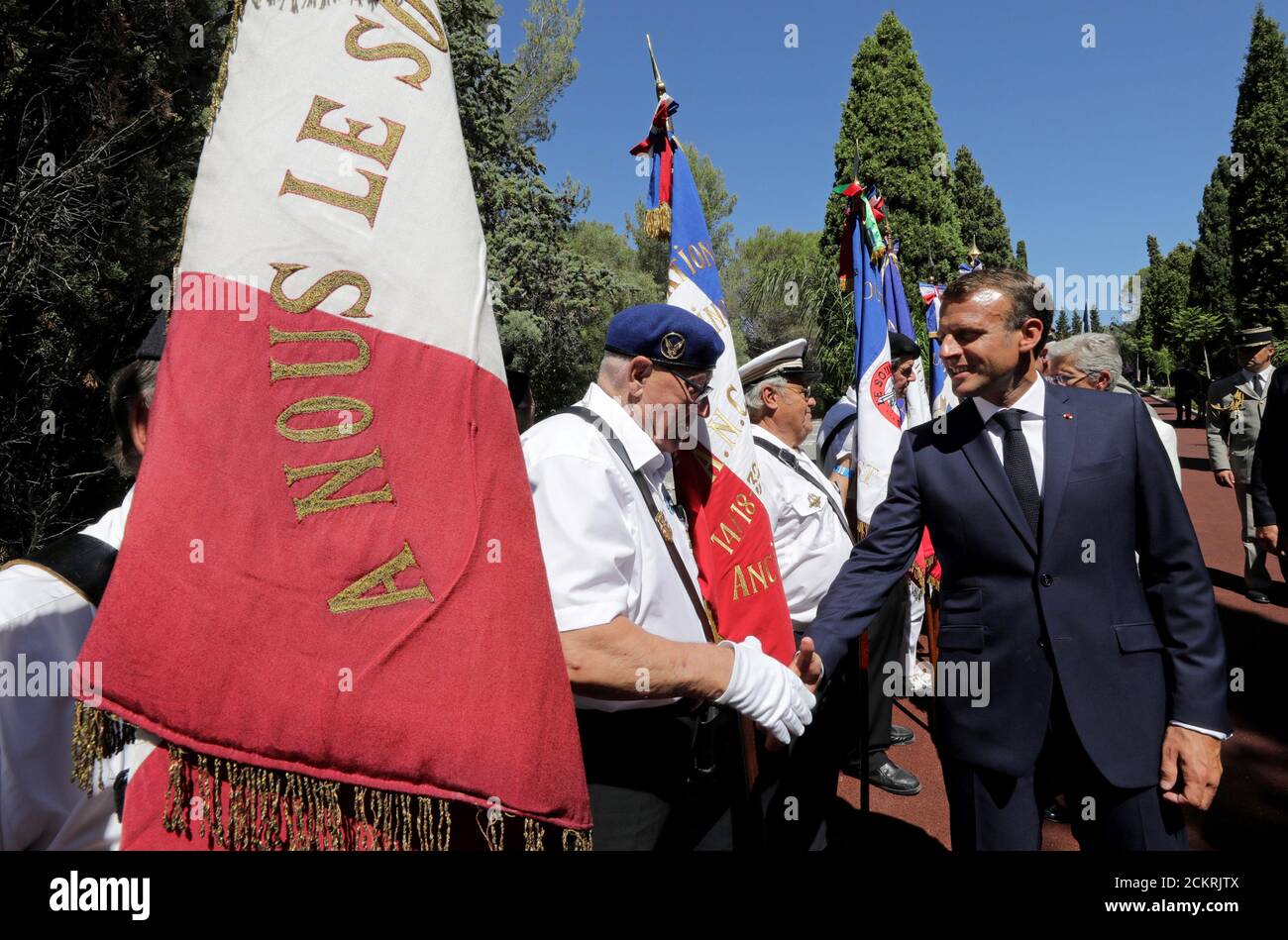 French President Emmanuel Macron shakes hands with a member of the Souvenir Francais during a ceremony marking the 75th anniversary of the Allied landings in Provence in World War Two which helped liberate southern France, in Boulouris, France, August 15, 2019.  REUTERS/Eric Gaillard/Pool Stock Photo
