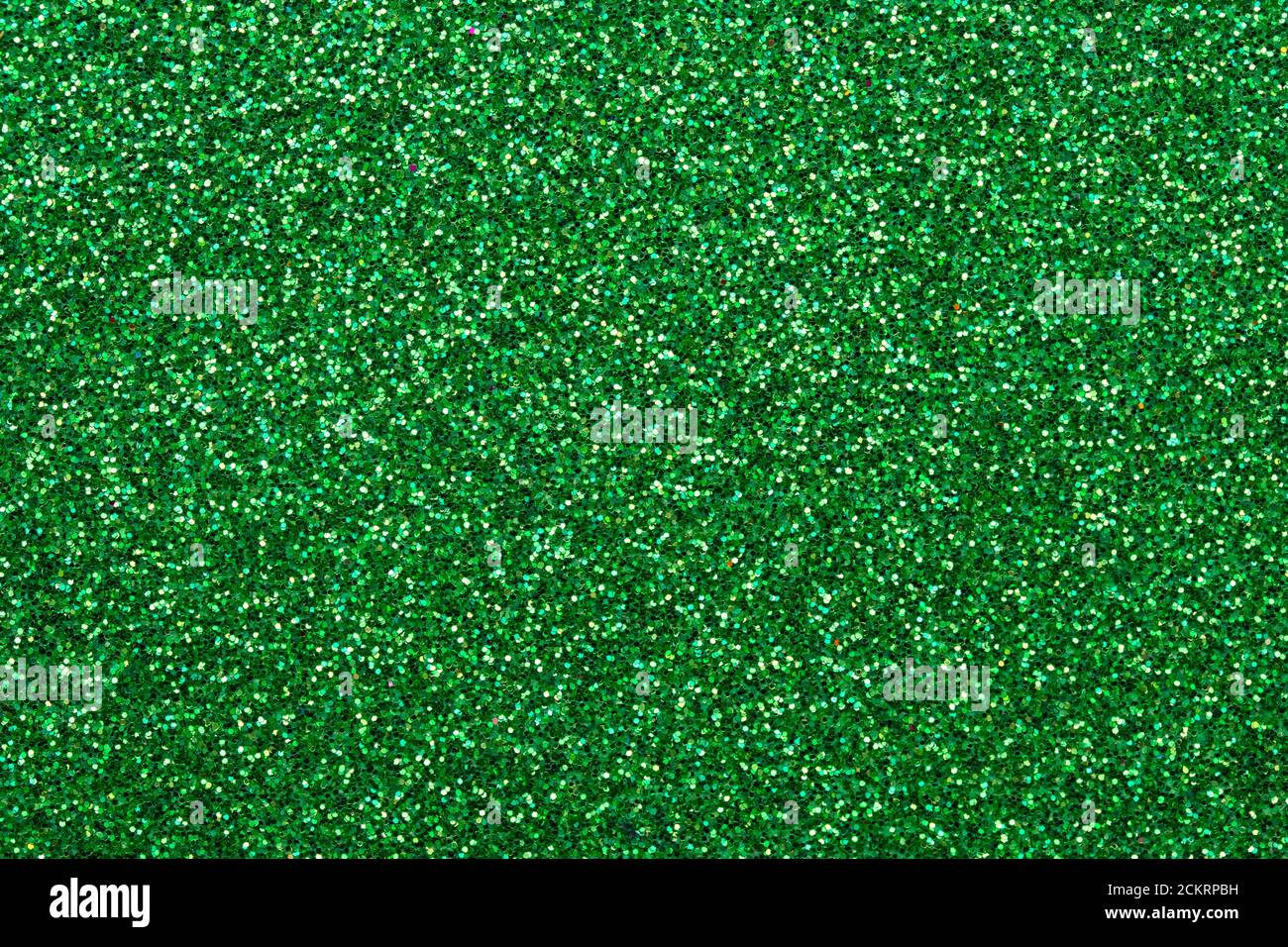 Shiny sequin fabric. Sparkle green texture, dark glitter background. Shimmering surface of textile. Abstract glister pattern. Brilliance backdrop. Hol Stock Photo