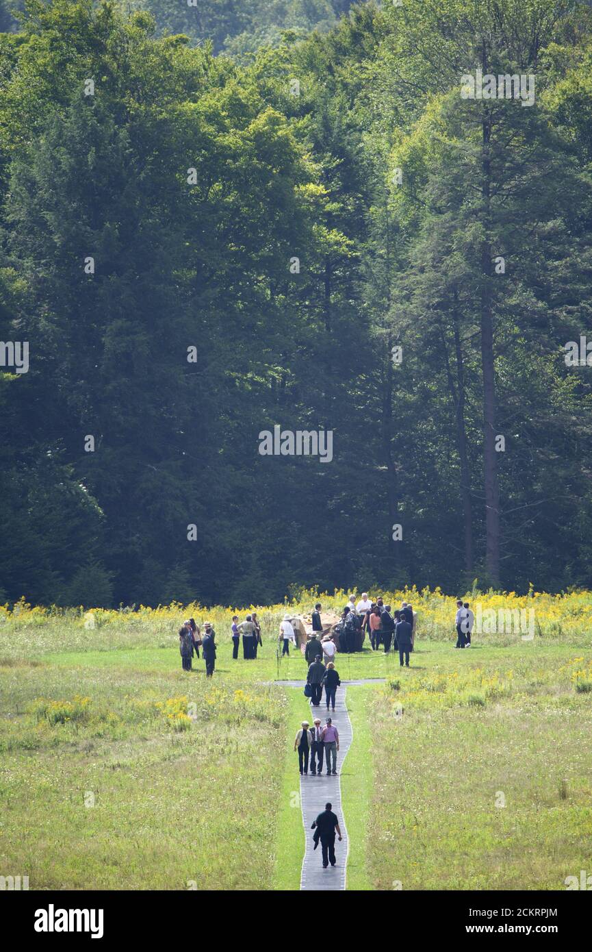 Family members of Flight 93 passengers that perished in the crash walk to the impact site, which is only opened for them once a year on September 11, in Shanksville, Pennsylvania September 11, 2015. An overcast Friday greeted relatives who gathered to commemorate nearly 3,000 people killed in the September 11 attacks in New York, Pennsylvania and outside Washington 14 years ago, when airliners hijacked by al Qaeda militants brought death, mayhem and destruction. REUTERS/Mark Makela Stock Photo