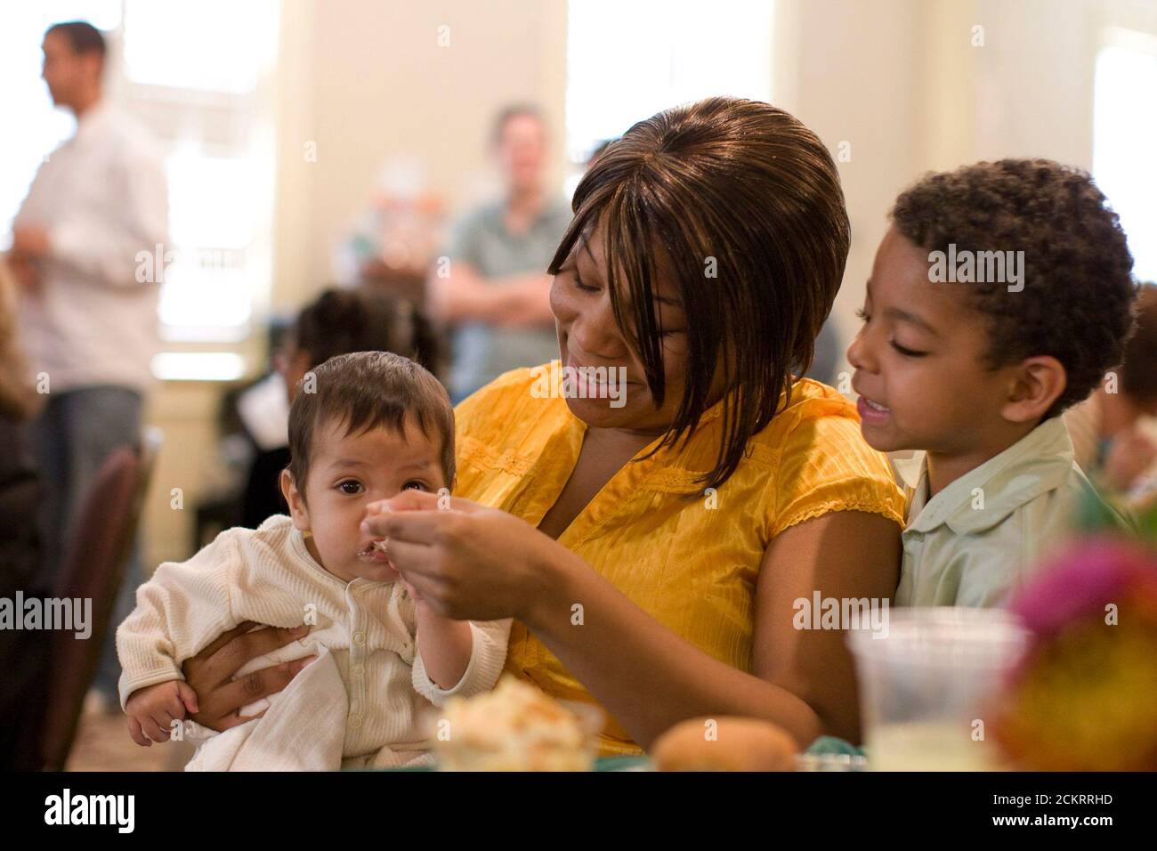 San Antonio, TX November 25, 2008: Baptist Child & Family Services (BCFS) Preparation for Adult Living (PAL) program annual Thanksgiving dinner for foster teens who are transitioning from state care to independent living with little or no traditional family support.  Child Protective Service worker Cheronda Tillman feeds the children of a client.  ©Bob Daemmrich Stock Photo