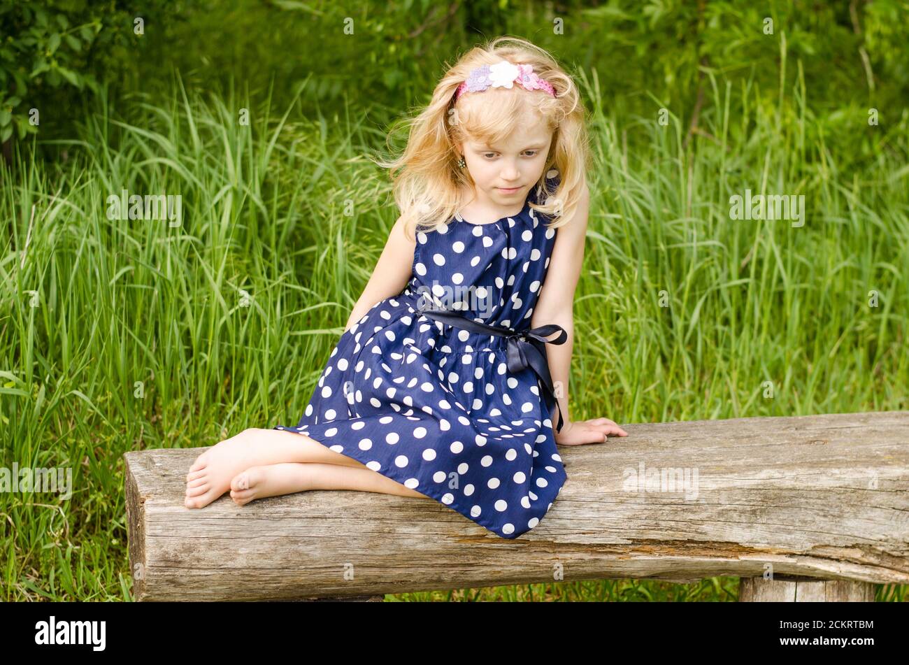 Sad girl sitting grass hi-res stock photography and images - Alamy