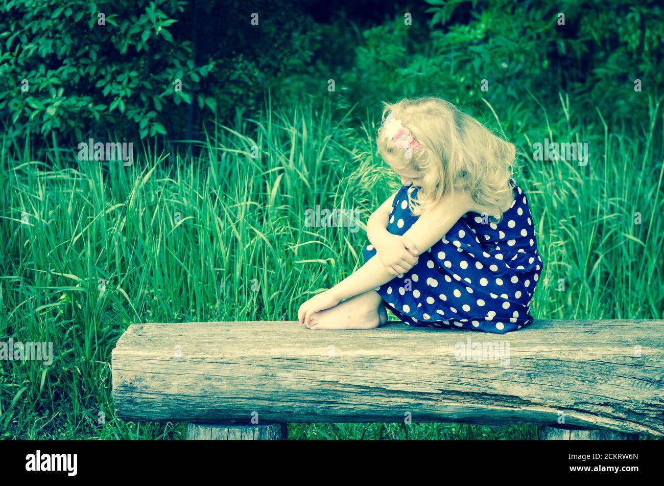 Sad girl sitting grass hi-res stock photography and images - Alamy