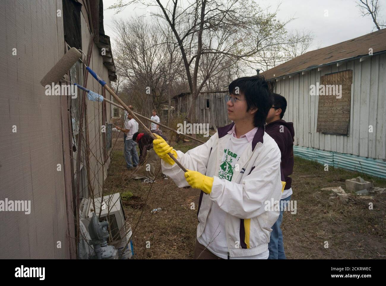 Austin, TX February 14, 2009: University of Texas at Austin students, including members of the Filipino-American Students Assn., work on sprucing up houses and public areas in east Austin as part of the second annual Clinton Global Initiative University, a conference bringing together students to take action on global challenges such as poverty, hunger, energy, climate change and global health. The program is patterned after Clinton Global Initiative Foundation formed by President Bill Clinton. ©Bob Daemmrich Stock Photo