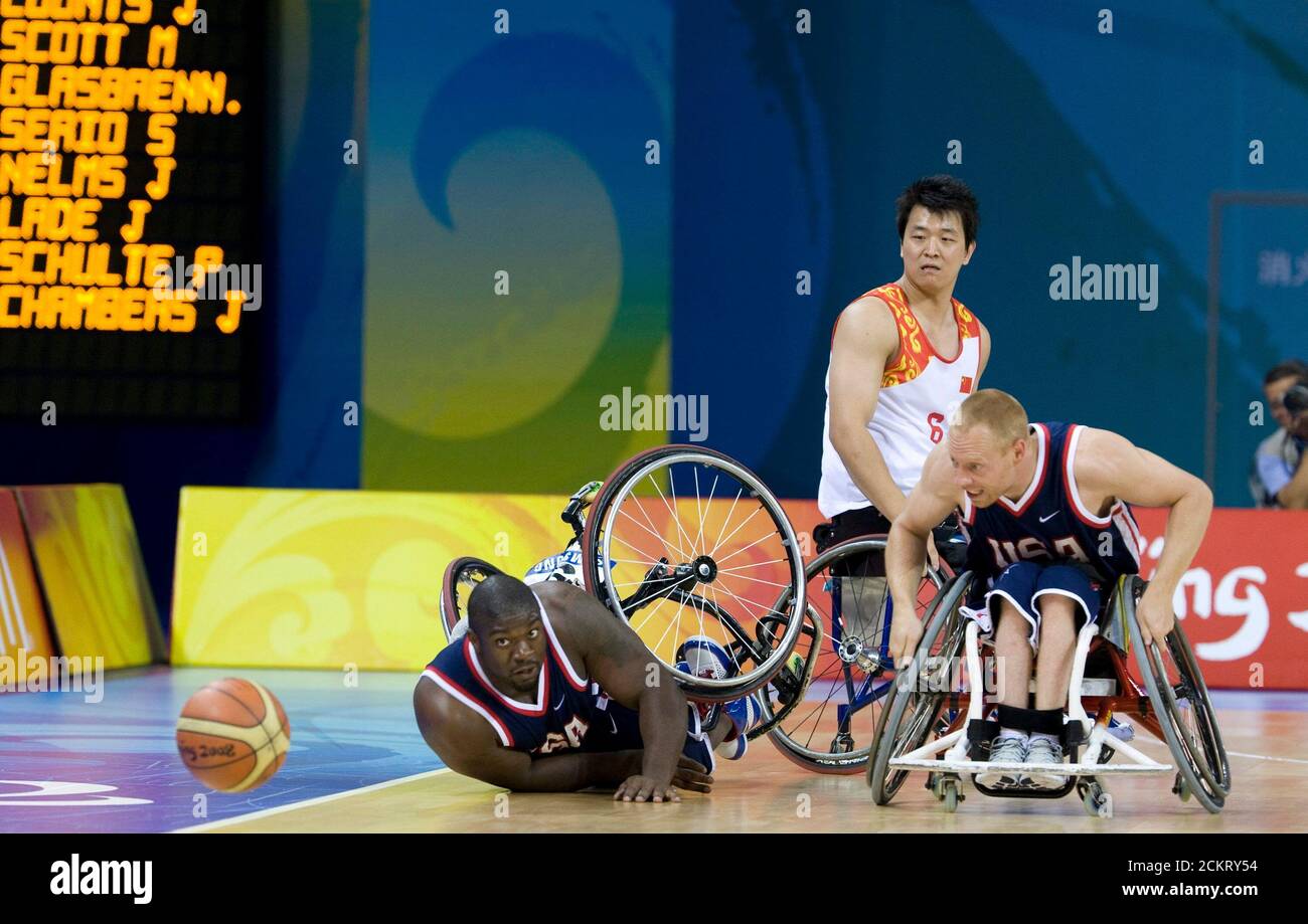 Beijing, China, September 10, 2008: Day four of athletic competition at the Beijing Paralympic Games with the U.S.'s Matt Scott (l) and Joe Chambers (r) eyeing the ball during a men's wheelchair basketball game. In the background is China's Lei Yang. The U.S. won, 97-38. ©Bob Daemmrich Stock Photo