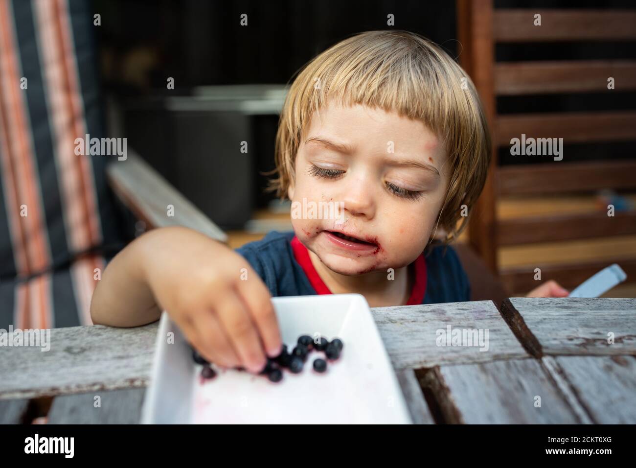Kid tasting berries hires stock photography and images Alamy