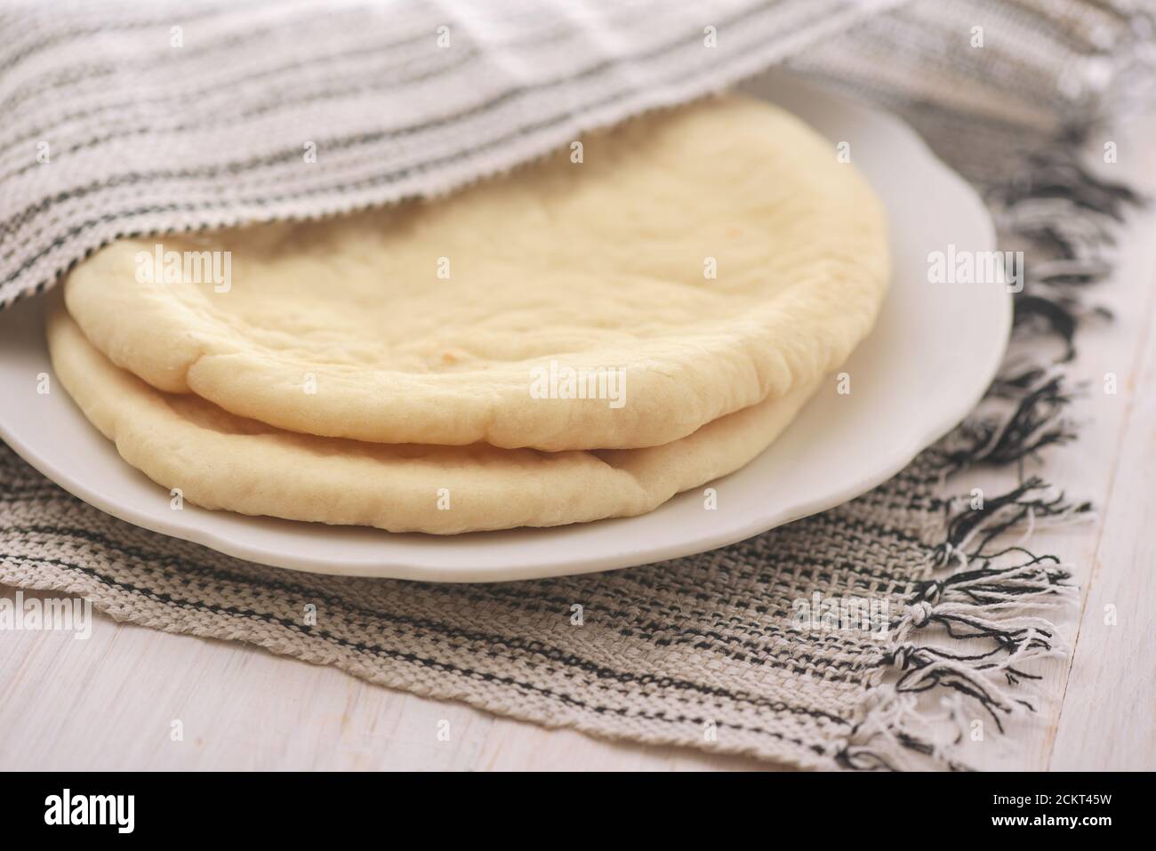 Closeup of uncooked flatbread on plate Stock Photo
