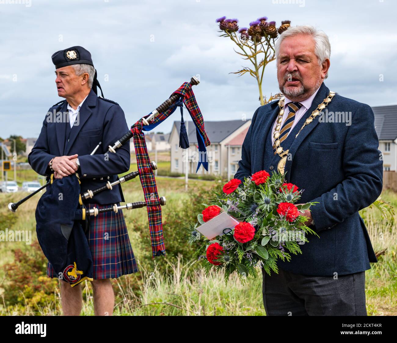 A piper with bagpipes & Provost John McmIllan with wreath at the Battle of Pinkie Cleugh commemoration, East Lothian, Scotland, UK Stock Photo