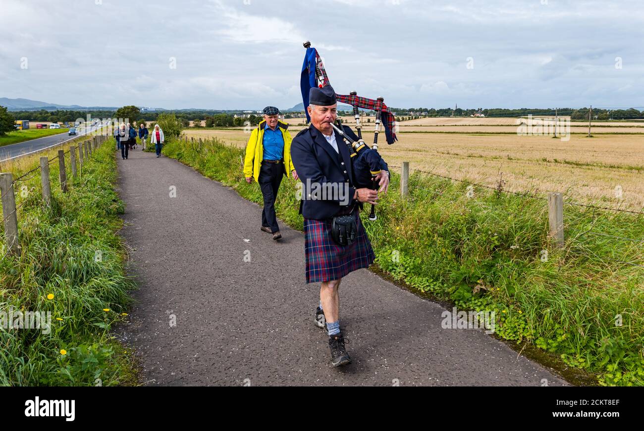 A piper leads a procession along the battlefield site at Battle of Pinkie Cleugh commemoration, East Lothian, Scotland, UK Stock Photo