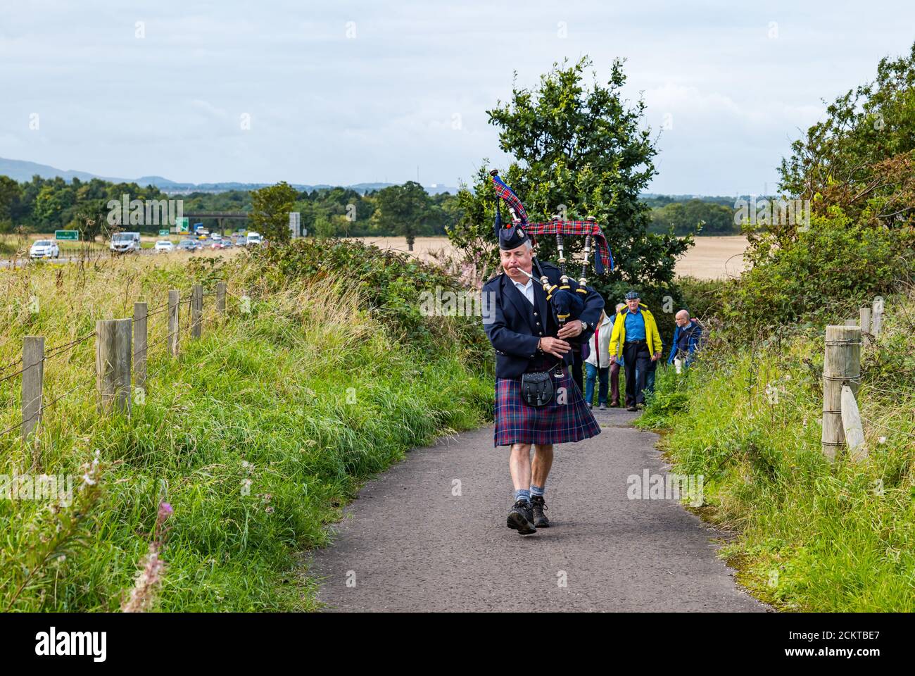 A piper leads a procession at the Battle of Pinkie Cleugh commemoration by the A1 battlefield site, East Lothian, Scotland, UK Stock Photo