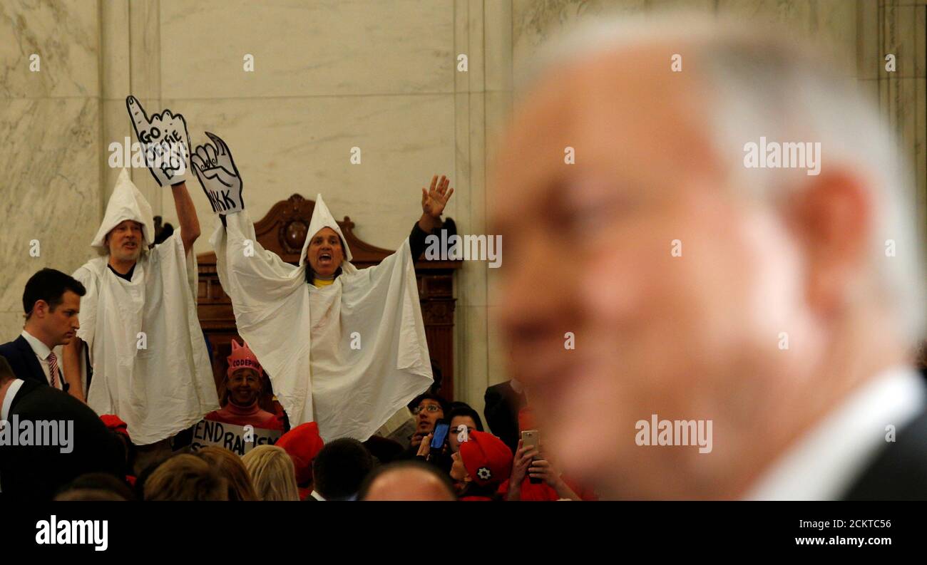 Protesters dressed as Klansmen disrupt the start of a Senate Judiciary Committee confirmation hearing for U.S. Attorney General-nominee Sen. Jeff Sessions on Capitol Hill in Washington, U.S. January 10, 2017. REUTERS/Kevin Lamarque Stock Photo