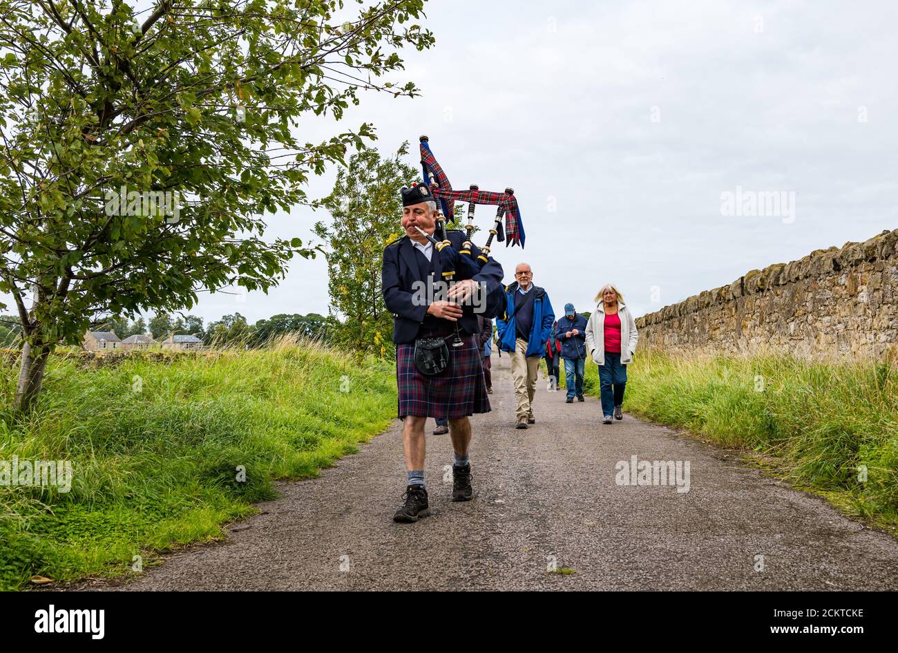A piper leads a procession at the Battle of Pinkie Cleugh commemoration, East Lothian, Scotland, UK Stock Photo