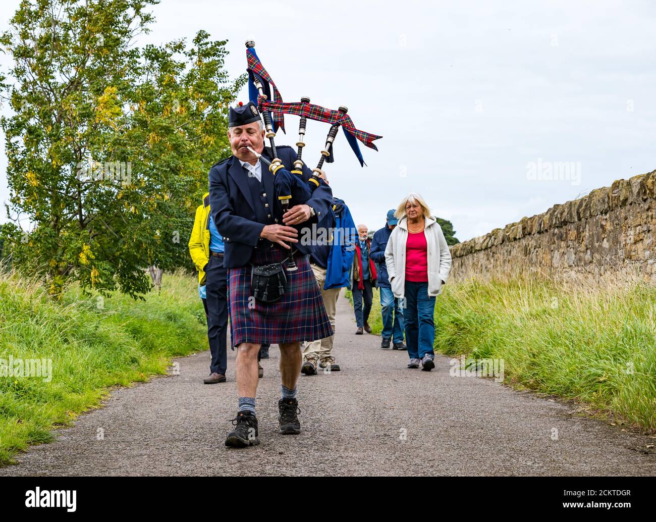 A piper leads a procession at the Battle of Pinkie Cleugh commemoration, East Lothian, Scotland, UK Stock Photo