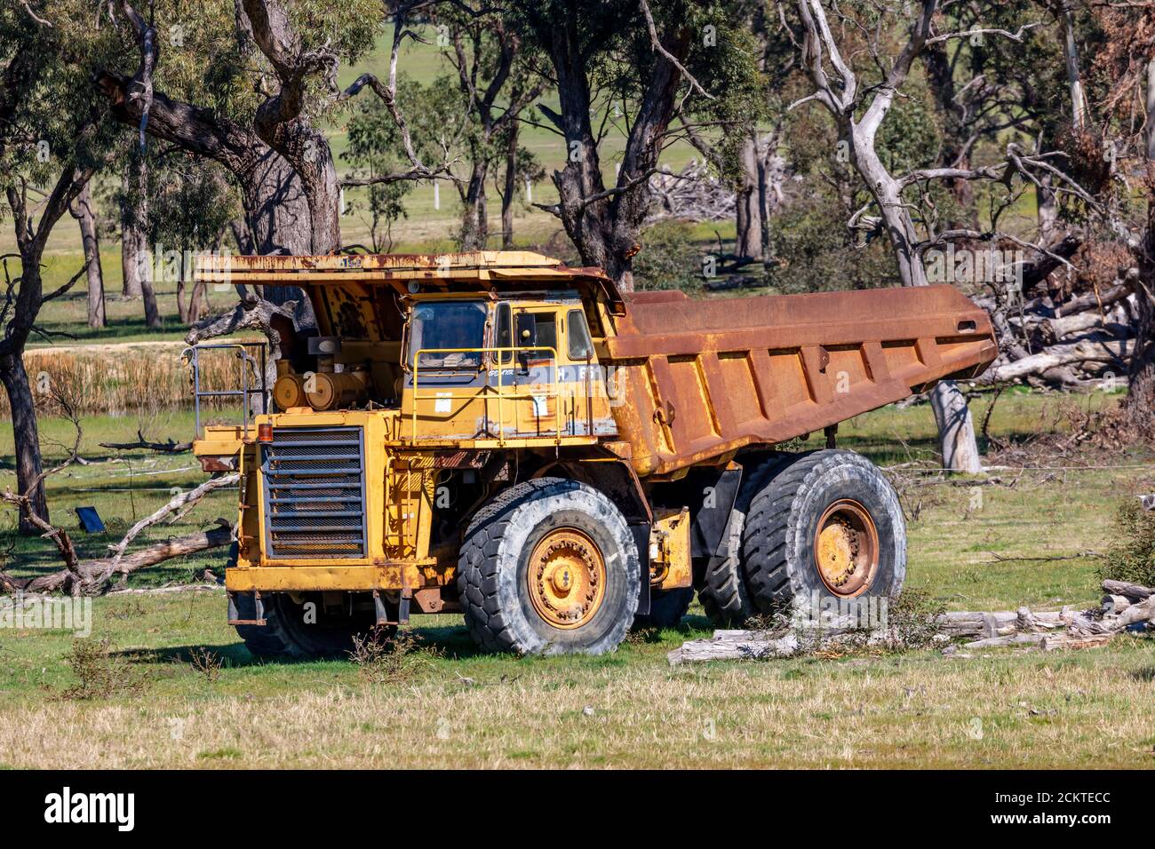 An old rusty earthmoving truck in a green field in regional Australia ...