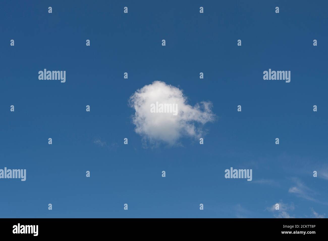 Single white cloud on a clear blue sky Stock Photo