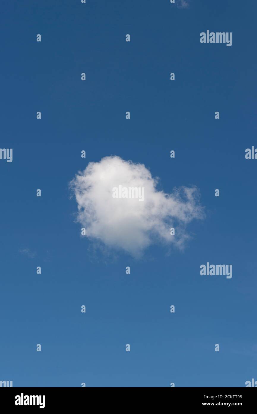 Single white cloud on a clear blue sky Stock Photo