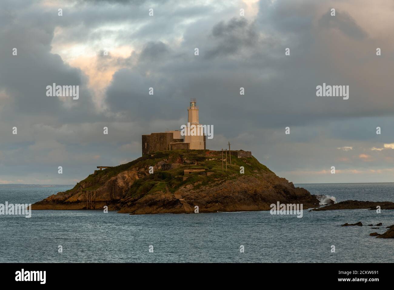 Offshore island with lighthouse on Mumbles Head in Swansea Bay Stock Photo