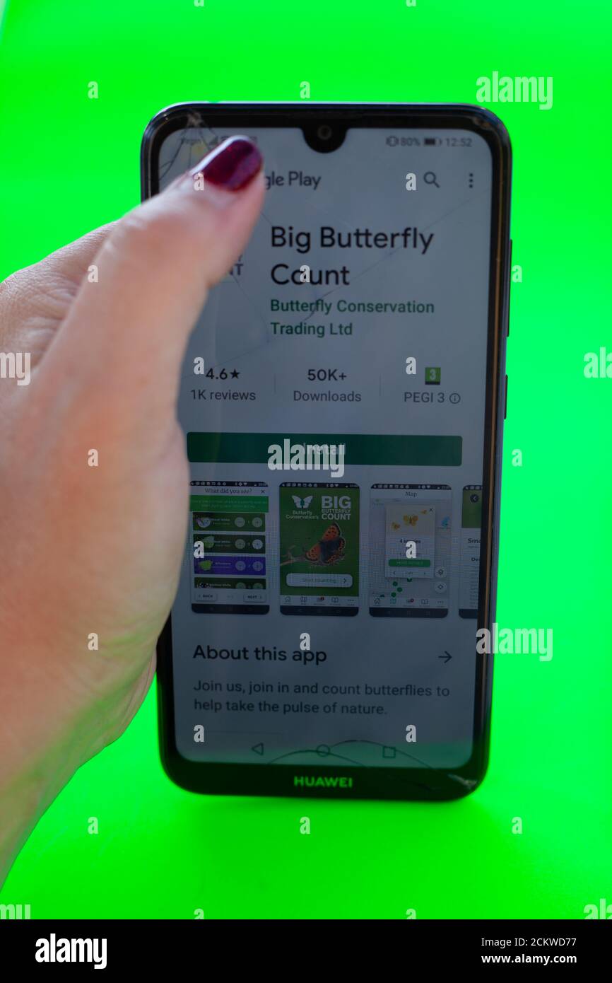 Tech lifestyle / Butterfly Conservation concept - View of a female hand ...