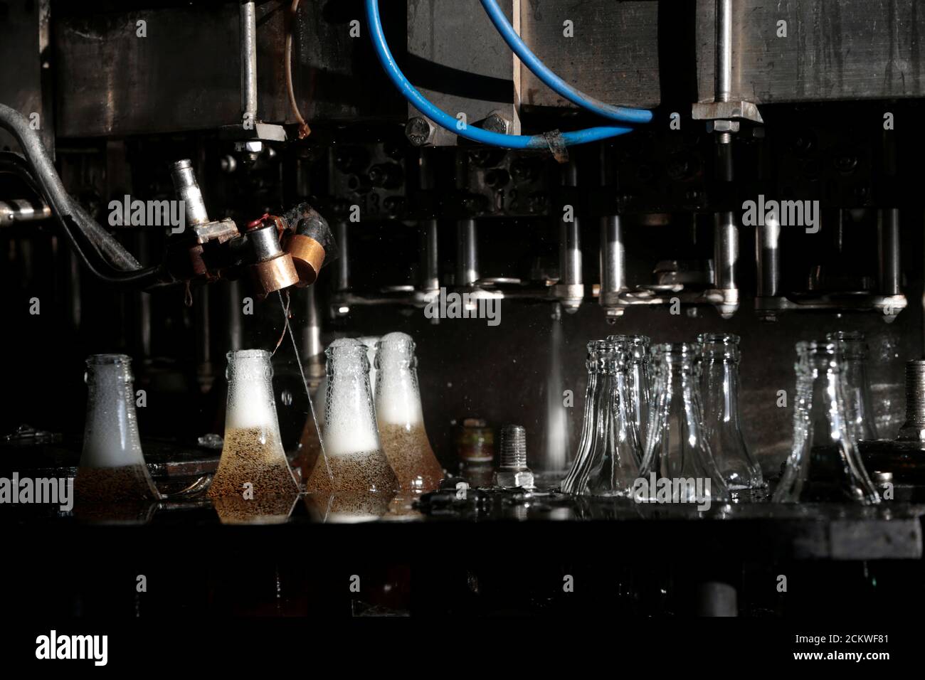 Bottles are filled with a lemon malt soft drink on the bottling line at