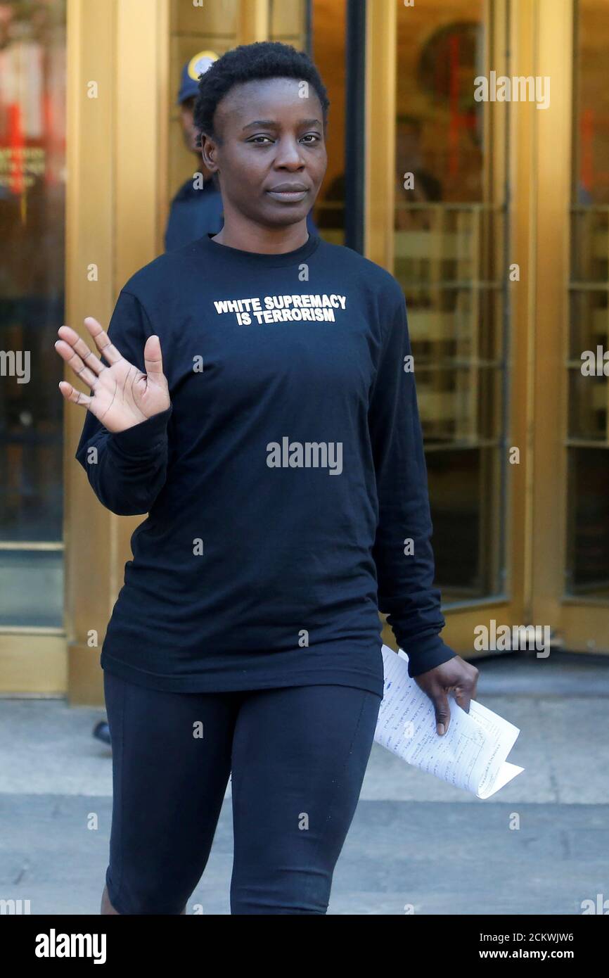Patricia Okoumou waves as she leaves federal court from her arraignment, a day after authorities say she scaled the stone pedestal of the Statue of Liberty to protest U.S. immigration policy, in Manhattan, New York, U.S., July 5, 2018. REUTERS/Shannon Stapleton Stock Photo