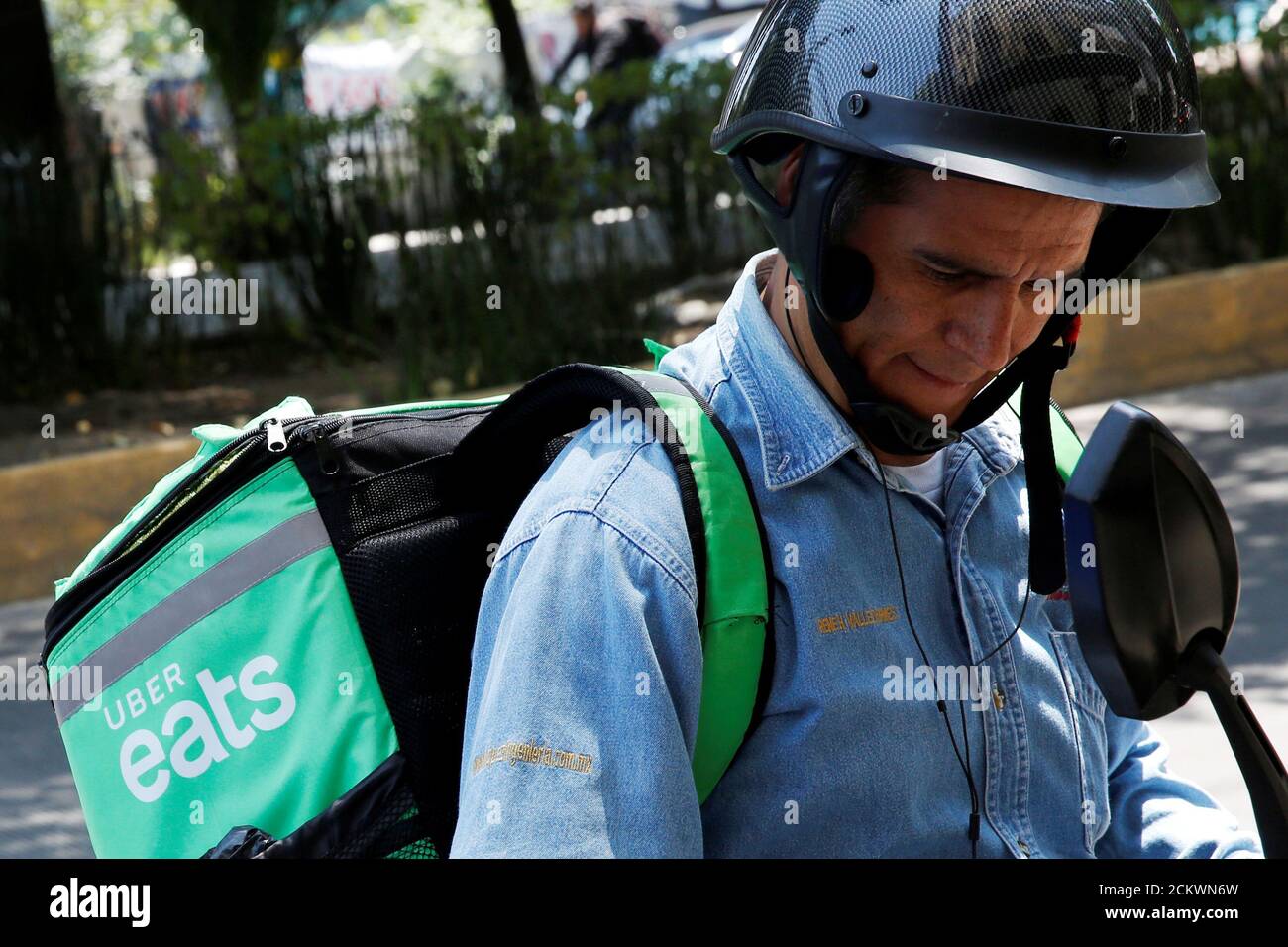 A man is seen with a delivery bag with the logo of Uber Eats in 