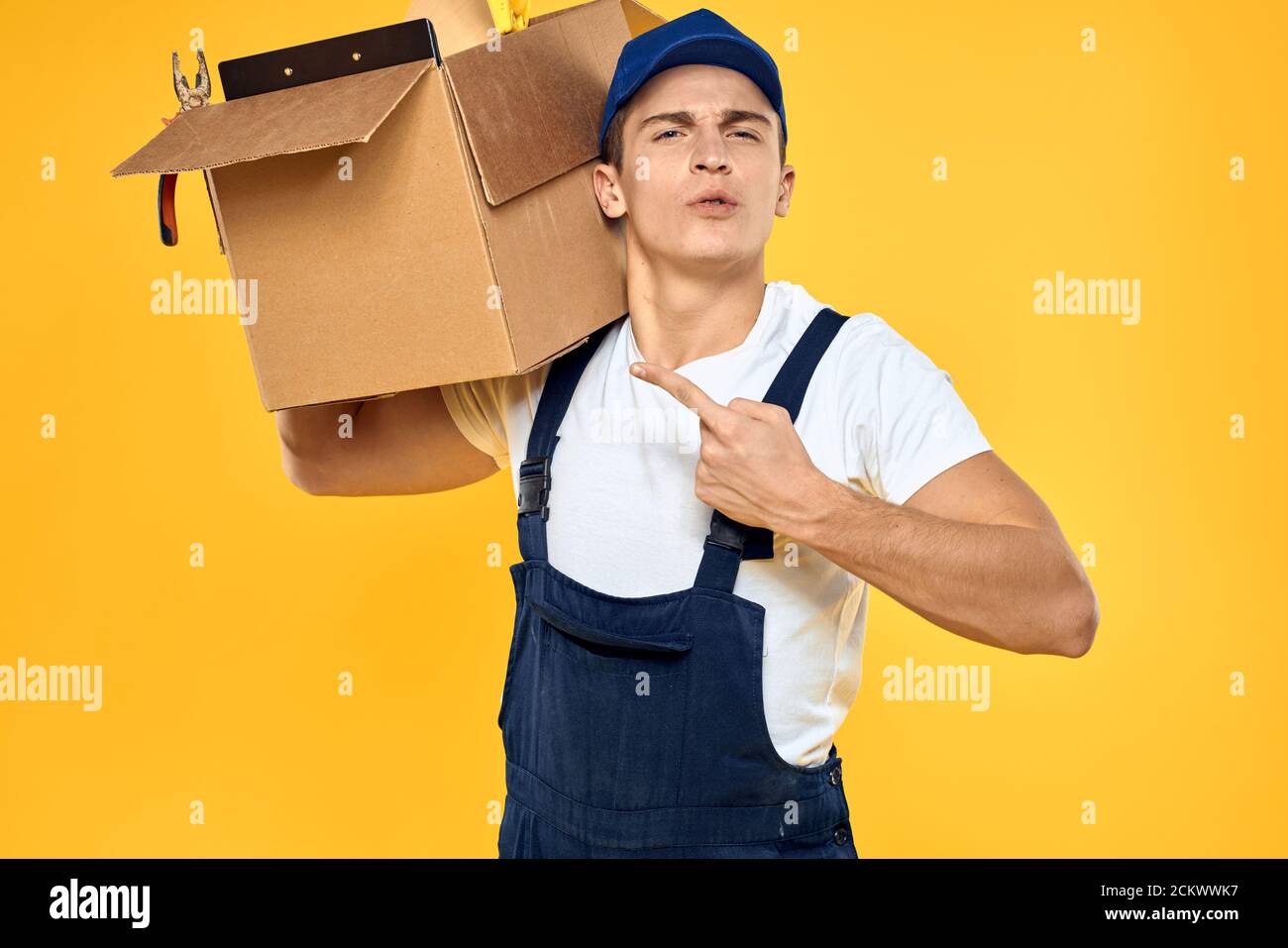 Working man in uniform with box hand delivery loading service yellow ...