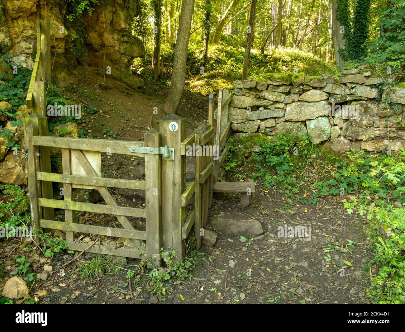 Old wooden gate, stile and stone walls, Ticknall Limeyards, Derbyshire, England, UK Stock Photo