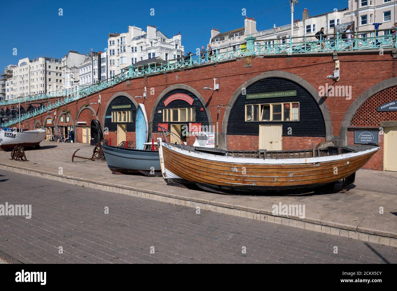 Brighton Fishing Museum on the seafront with tourists enjoying the warm and sunny day. Stock Photo