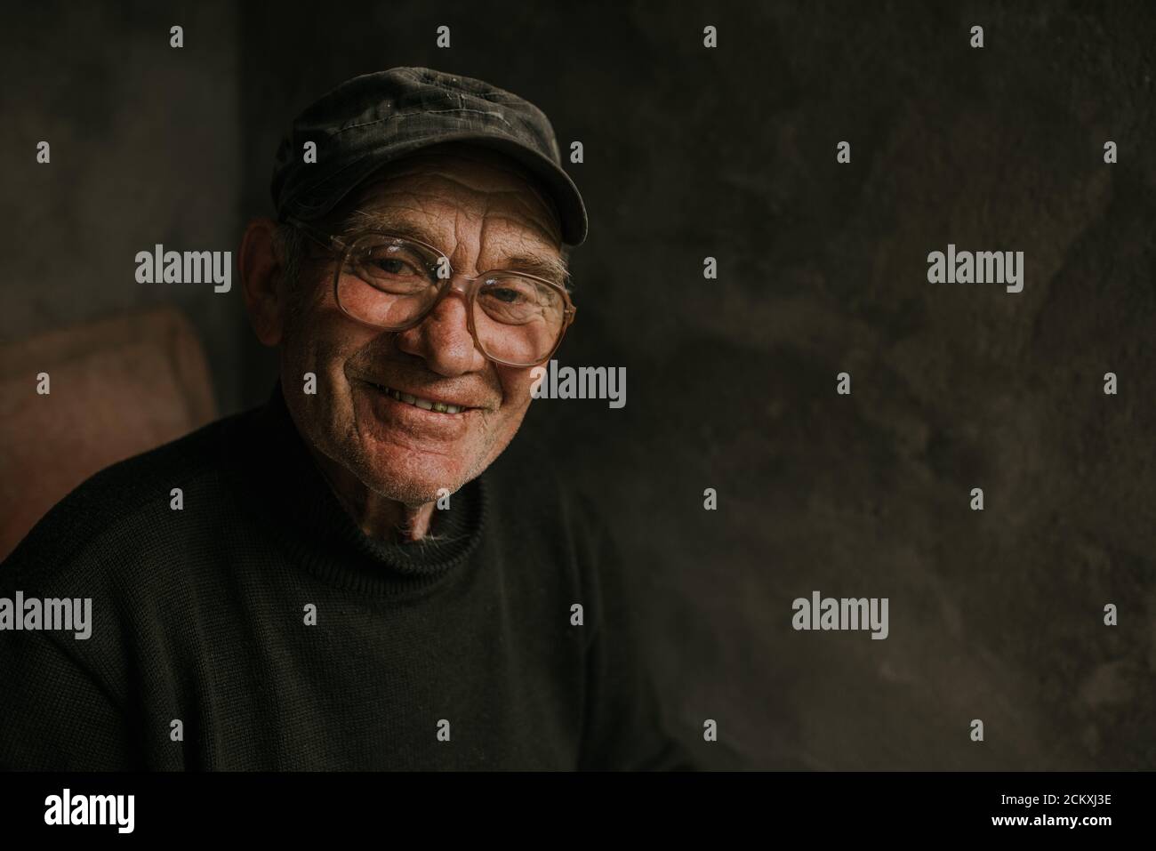 Pensive old man in glasses with gray hair Stock Photo