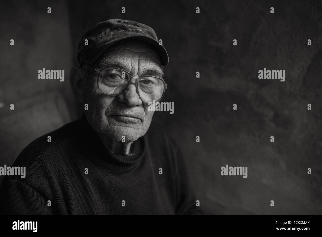 Pensive old man in glasses with gray hair Stock Photo