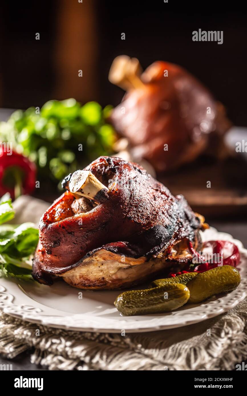 Smoked pork ham hock, pork knee served with pickled cucumbers and herbs