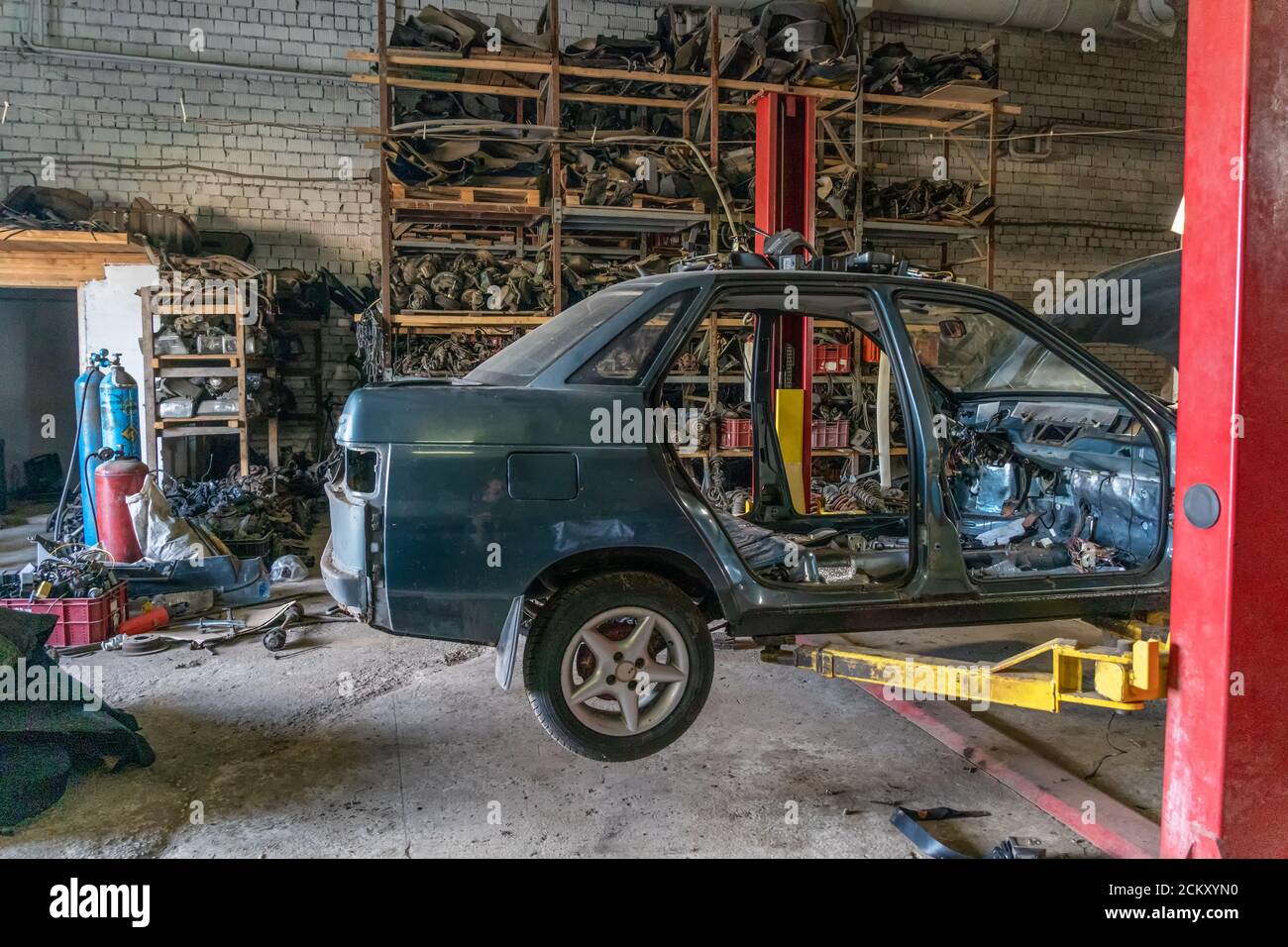 Car body on the lift, disassembly Stock Photo Alamy