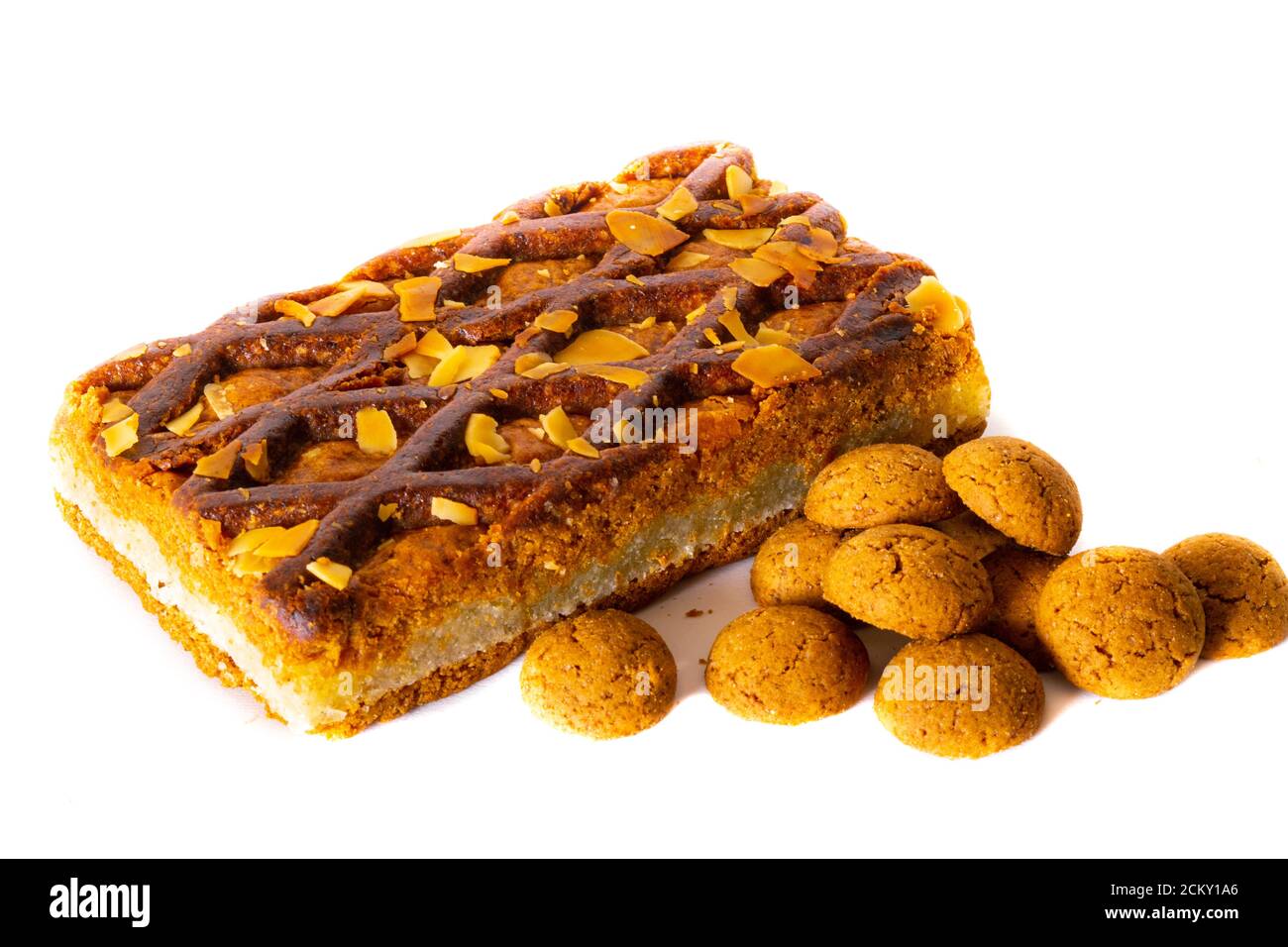 A Gevulde Speculoos lie next to a Dutch traditional candy called 'Pepernoten' on a white background, Pepernoten is a candy for the Dutch fest Sinterkl Stock Photo