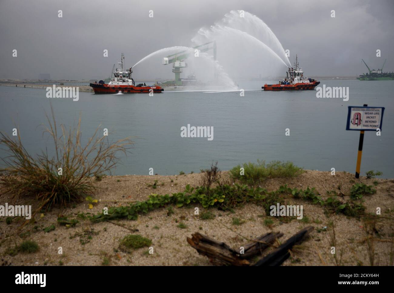 Vessels present a water salute for the installation of the final caisson for Tuas Terminal Phase 1 reclamation in Singapore April 23, 2019. REUTERS/Edgar Su Stock Photo