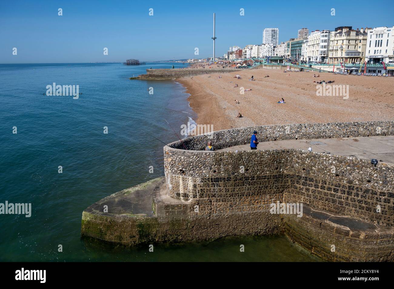 Brighton beach with a groyne popular for fishing and the beach and seafront also in view. Stock Photo