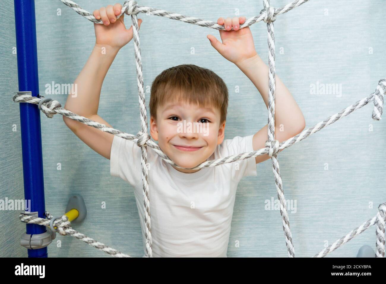 Boy schoolboy understates sports on Swedish house wall Stock Photo