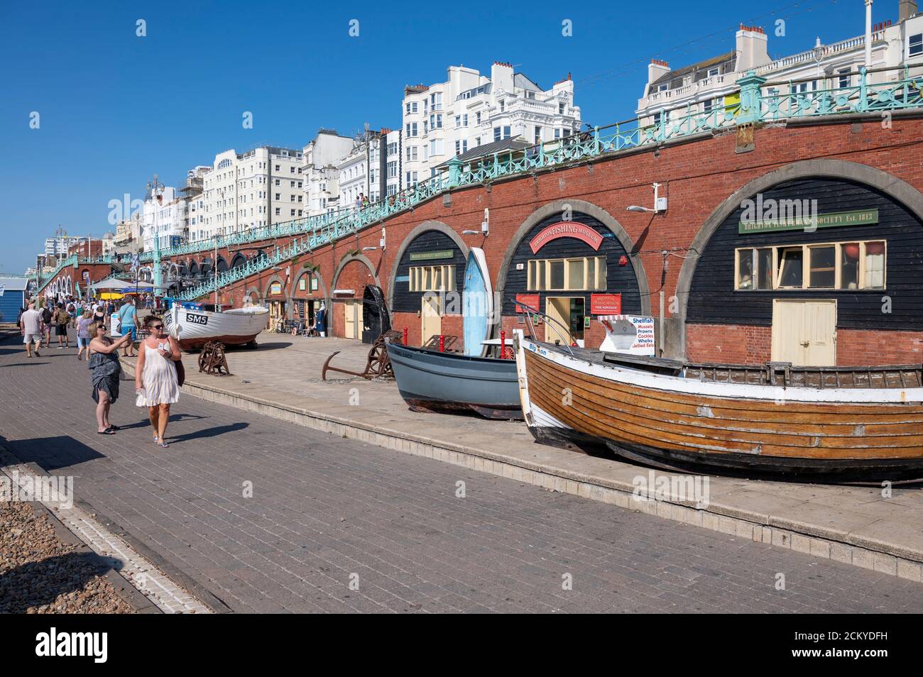 Brighton Fishing Museum on the seafront with tourists enjoying the warm and sunny day and taking photos. Stock Photo