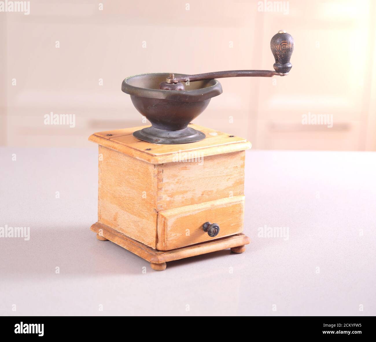 Old obsolete manual coffee grinder made of wood and iron Stock Photo